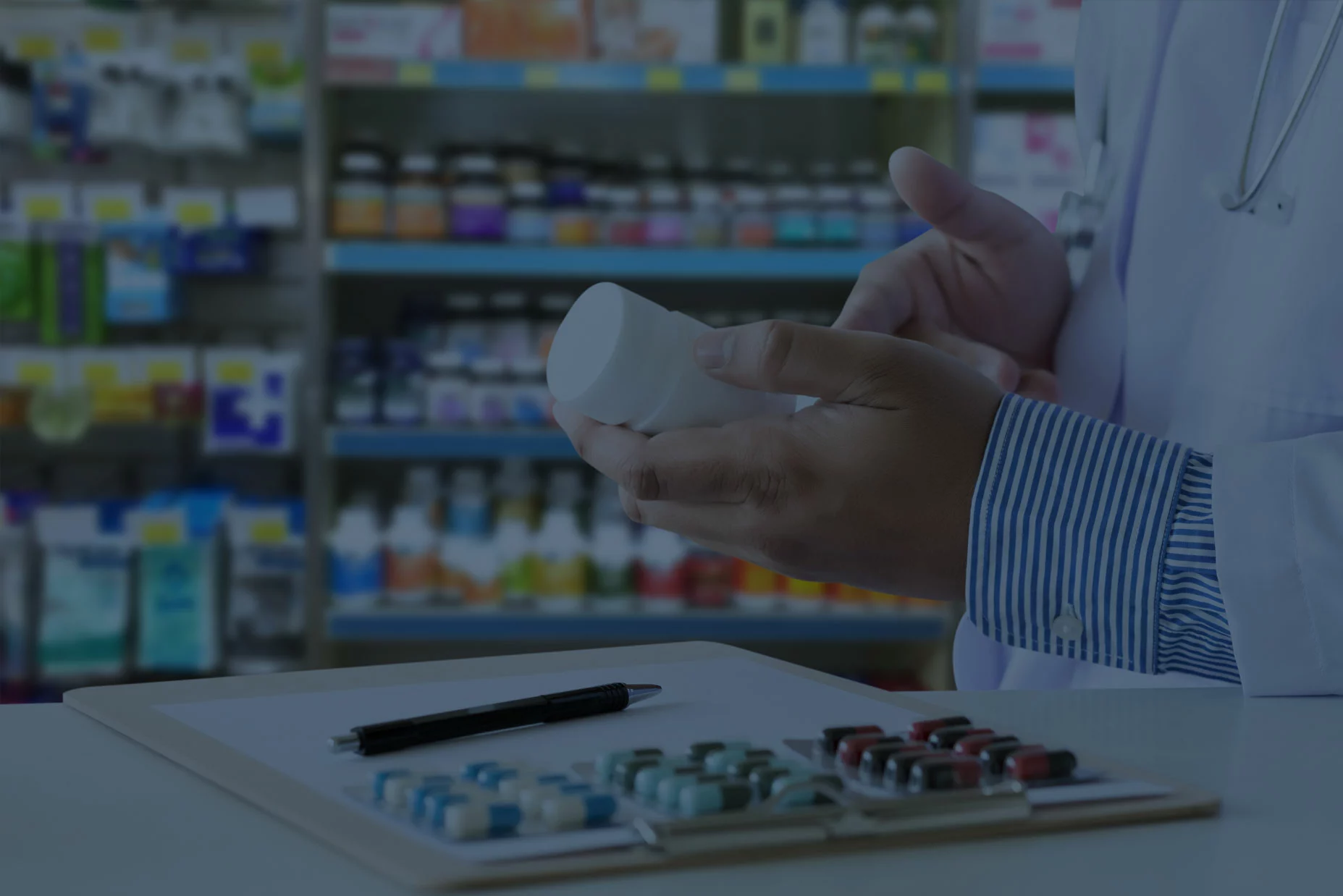 Pharmacist reading the label of a prescription bottle