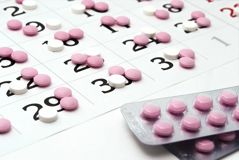 multiple prescription pills on days on a calendar