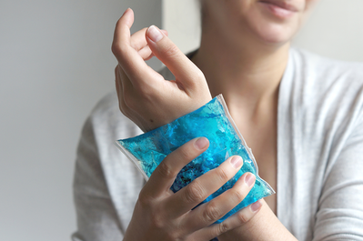 woman holding ice pack on wrist