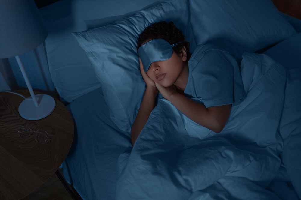 woman sleeping while wearing eye mask