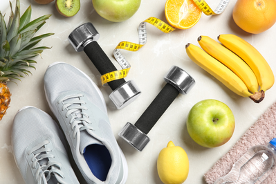 sneakers, weights, tape measure, and fruits