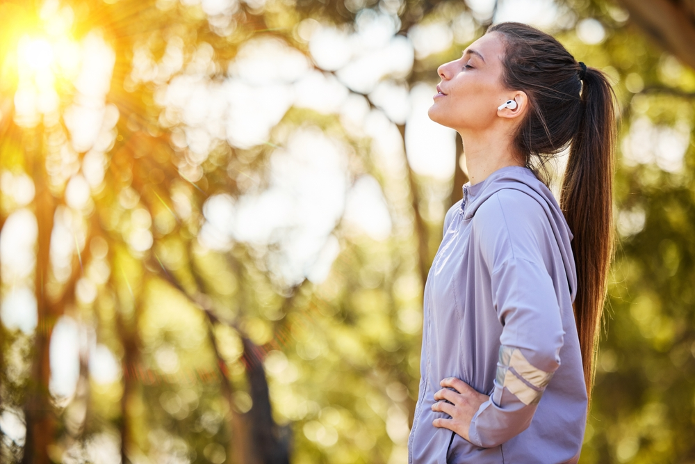 young woman soaking up sun on morning walk